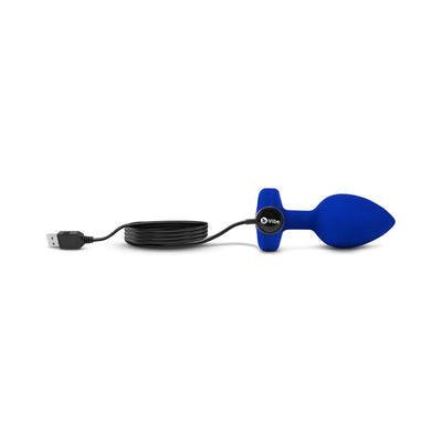 Blue sapphire vibrating plug with USB charging cable and control button on a white background.