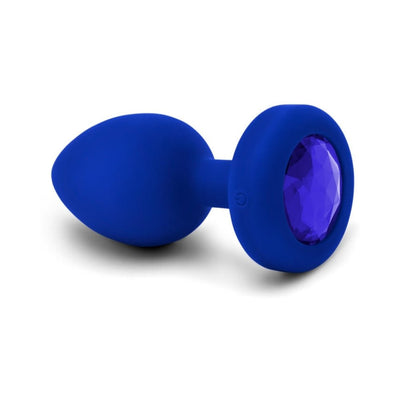 Blue sapphire vibrating plug with smooth silicone body and faceted jewel base, USB rechargeable and ergonomic design.
