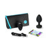 B-Vibe Vibrating Jewel Plug 2XL with remote, USB charging cable, guide booklet, and black storage pouch with blue zipper.