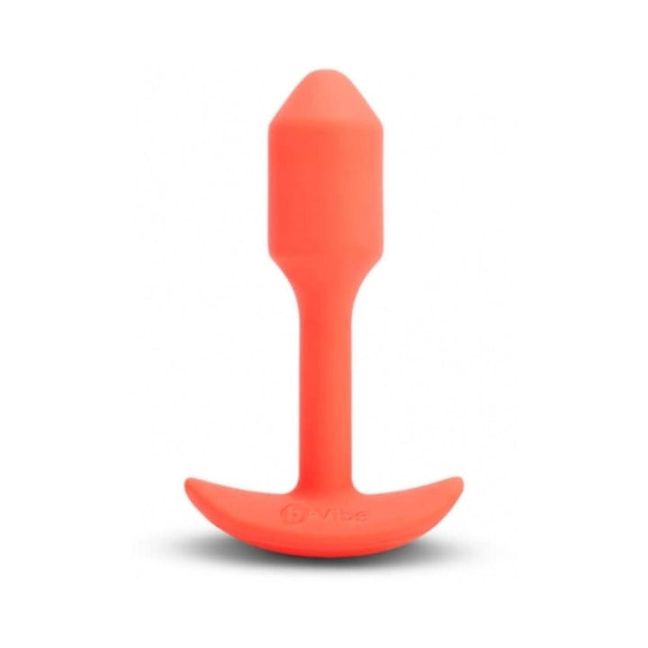 Small orange b-Vibe Vibrating Snug Plug made of smooth silicone with a curved base for comfort and control.