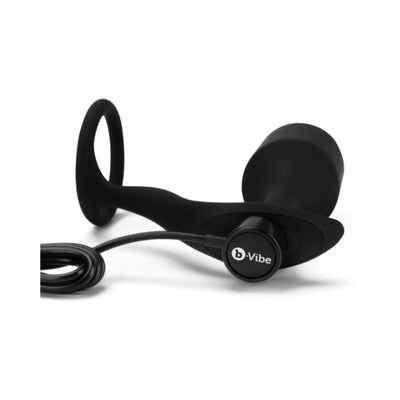 Black silicone b-Vibe Vibrating Snug & Tug XL with penis ring and weighted plug, shown with magnetic USB charging cable.