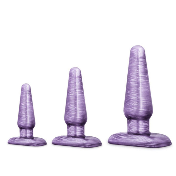 Set of three purple swirl tapered anal trainer plugs in small, medium, and large sizes with flexible bases for safety.