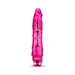 Pink translucent vibrator with realistic shape and textured shaft, featuring a twist dial base for adjustable vibration.