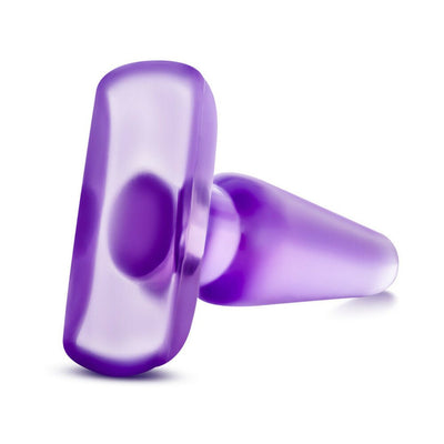 Medium-sized purple tapered anal plug with a wide base, made from smooth translucent material.
