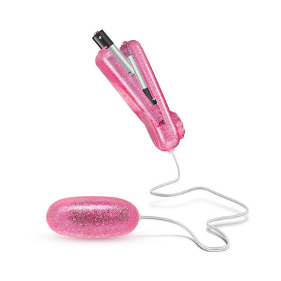 Pink glittery bullet vibrator with wired remote control and visible battery compartment on white background.
