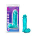 Teal 9-inch realistic dildo with balls and suction cup base displayed next to its purple and blue packaging.