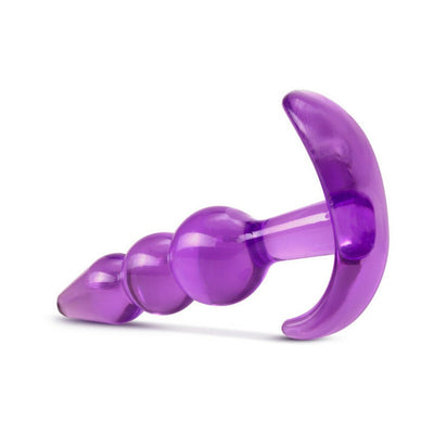 Purple triple bead anal plug with a curved base, made from smooth, translucent material for comfort and stimulation.