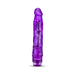 Purple translucent vibrator with realistic shape and textured surface, featuring a twist dial base for adjustable vibrations.