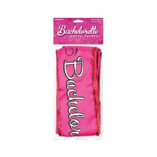 Pink bachelorette party sash with black and white lettering and red sequin trim in packaging