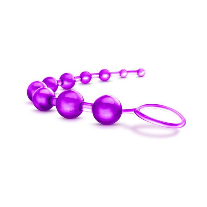 Purple flexible anal beads with graduated sizes and a loop handle for easy use and retrieval.