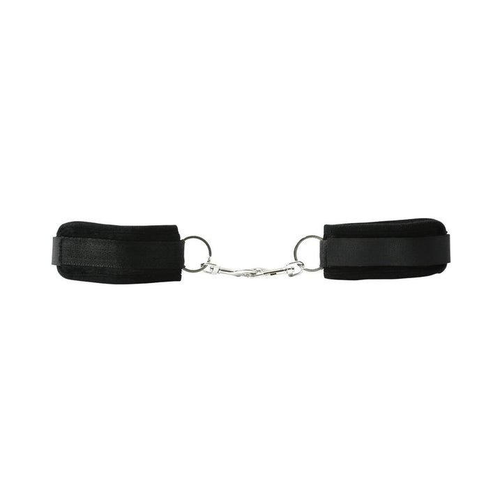 Black beginner's handcuffs with soft Velboa lining and metal snap link connector for easy adjustment and secure fit.