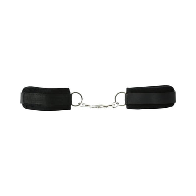 Black beginner's handcuffs with soft Velboa lining and metal snap link connector for easy adjustment and secure fit.