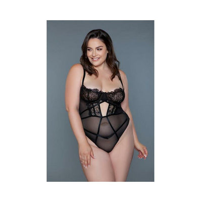 Plus size model wearing black lace and mesh BeWicked Cameryn Bodysuit with underwire cups and adjustable straps.