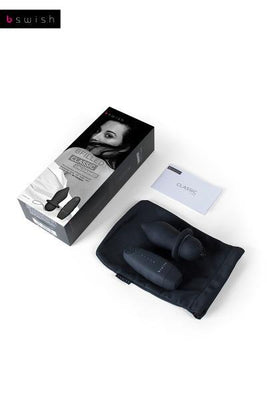 B Swish Bfilled Classic Unleashed black plug with wireless remote, storage pouch, and instruction manual on white background.