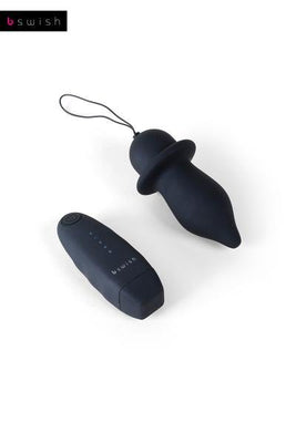 Black B Swish Bfilled Classic Unleashed tapered plug with pull-string and wireless remote control on white background.