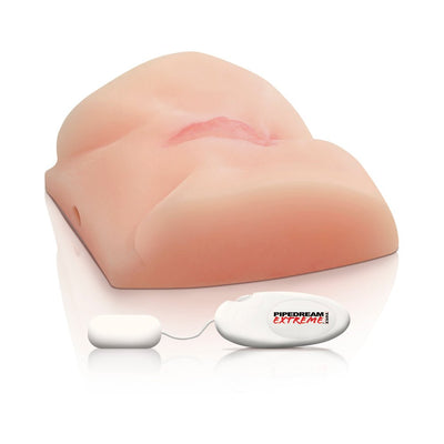 Beige lifelike vibrating masturbator with remote control on a white reflective surface.