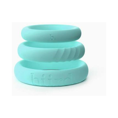 Stacked set of three mint-colored silicone C-rings with smooth and textured designs.