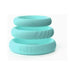Stacked set of three mint-colored silicone C-rings with smooth and textured designs.