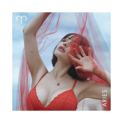 Woman in red lace bralette and red sheer fabric showcasing Aries zodiac symbol and red jasper necklace.