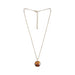 Gold chain necklace with a round Tiger Eye gemstone pendant for Gemini zodiac sign.