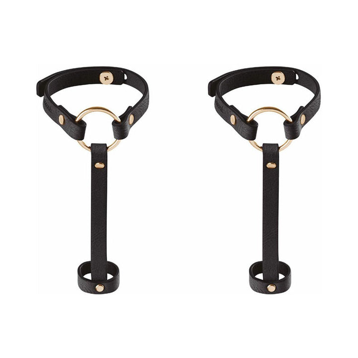 Pair of black vegan leather hand bracelet harnesses with gold-tone rings and adjustable straps.