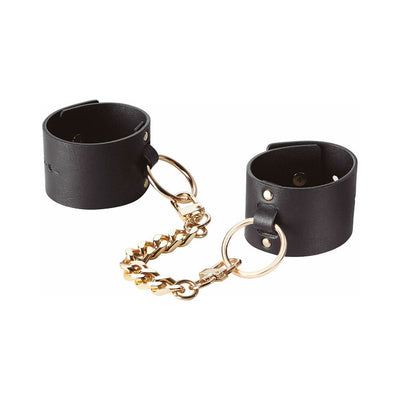 Black wide vegan leather cuffs connected by a detachable gold-tone chain with large rings and clasp closures.