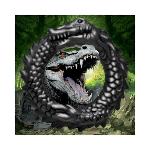 Black silicone cock ring shaped like a grinning caiman with textured ridges and bumps.