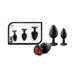 Set of three black silicone plugs in small, medium, and large sizes with heart-shaped bases featuring red gems, displayed with packaging.
