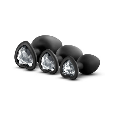 Three black silicone heart-shaped base plugs in small, medium, and large sizes with white gem accents.