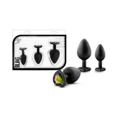 Three black silicone plug trainers in small, medium, and large sizes with heart-shaped bases featuring iridescent white gems, displayed with packaging.