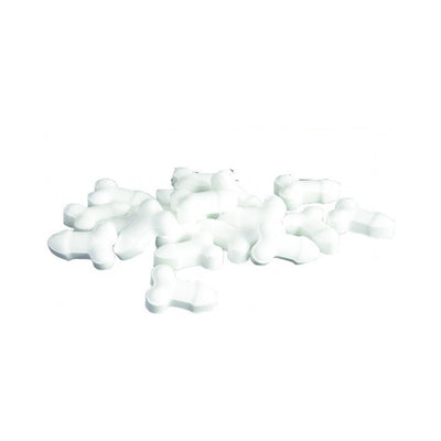 White mints shaped with a playful embossed design, scattered on a white background.