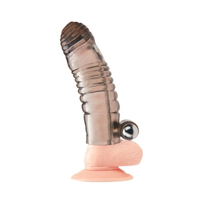 Blue translucent vibrating penis sleeve extension with textured ridges and attached vibrating bullet on a flesh-toned base with suction cup.