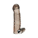 Transparent textured vibrating penis sleeve extension with ridged tip and included small bullet vibrator on white background.
