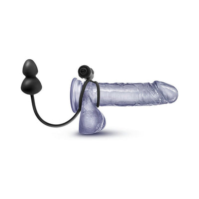 Black silicone anal plug with vibrating C-ring displayed on a transparent model.