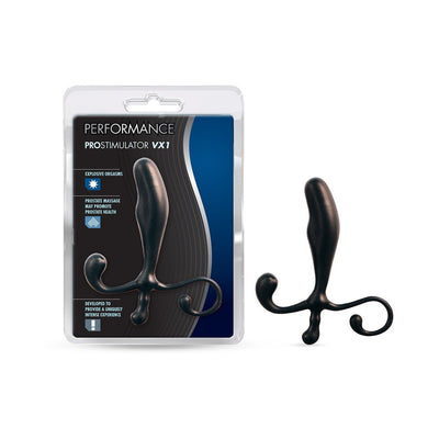 Blush Performance Prostimulator VX1 black prostate massager with ergonomic curved design and flexible handles next to its packaging.