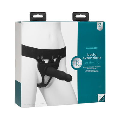 Packaging of Body Extensions Be Daring Hollow Slim Dong Strap On Set in black showing adjustable harness and silicone attachment on mannequin.