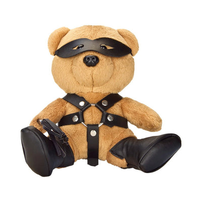 Plush teddy bear wearing black faux leather harness, boots, eye mask, and holding a small flogger accessory.