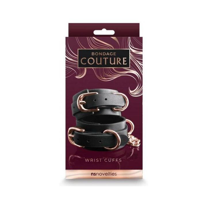 Black synthetic wrist cuffs with rose gold buckles and hardware displayed on elegant Bondage Couture packaging.