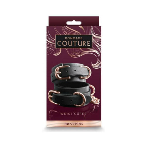 Black synthetic wrist cuffs with rose gold buckles and hardware displayed on elegant Bondage Couture packaging.