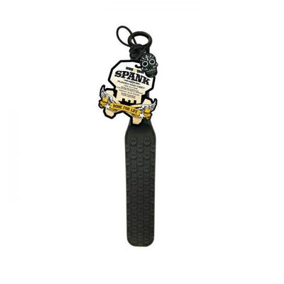 Black silicone paddle with raised skull design, hanging loop, and attached skull keychain tag.