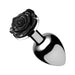 Small sleek metal anal plug with a decorative black rose base, polished and reflective finish.