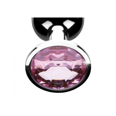 Close-up of a sleek metal anal plug with a large pink gem at the base, showcasing its polished finish and elegant design.