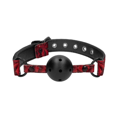 Breathable black ball gag with adjustable burgundy strap featuring diamond pattern and metal buckle details.