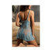 Back view of woman wearing light blue sheer lace chemise with floral details and matching G-string lingerie set.