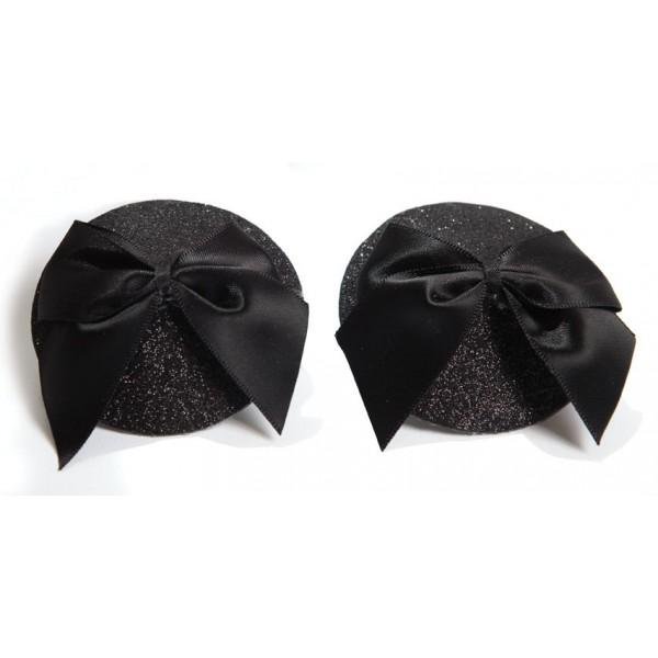 Black glittery round pasties adorned with large satin bows for a glamorous burlesque look.