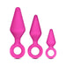 Set of three pink silicone anal training plugs in small, medium, and large sizes with ring handles for easy use.