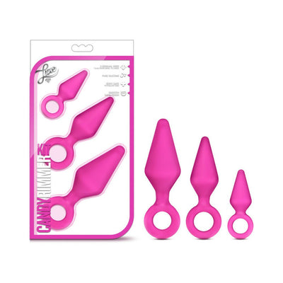 Set of three pink silicone anal training plugs in small, medium, and large sizes with ring handles, displayed with packaging.