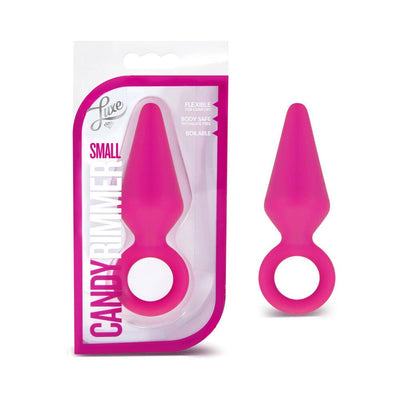 Small pink silicone Candy Rimmer plug with tapered design and safety ring, shown in and out of packaging.