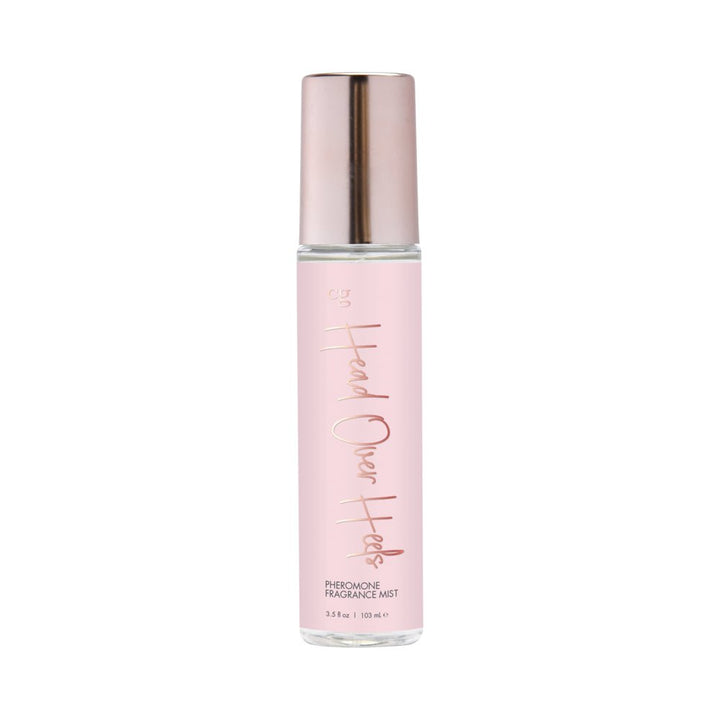 Cgc Head Over Heels pheromone fragrance mist in a pink bottle with rose gold cap and lettering, 3.5 oz size.