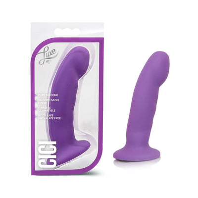 Purple Cici Pure Silicone dildo with smooth satin finish shown in packaging and standing upright outside box.